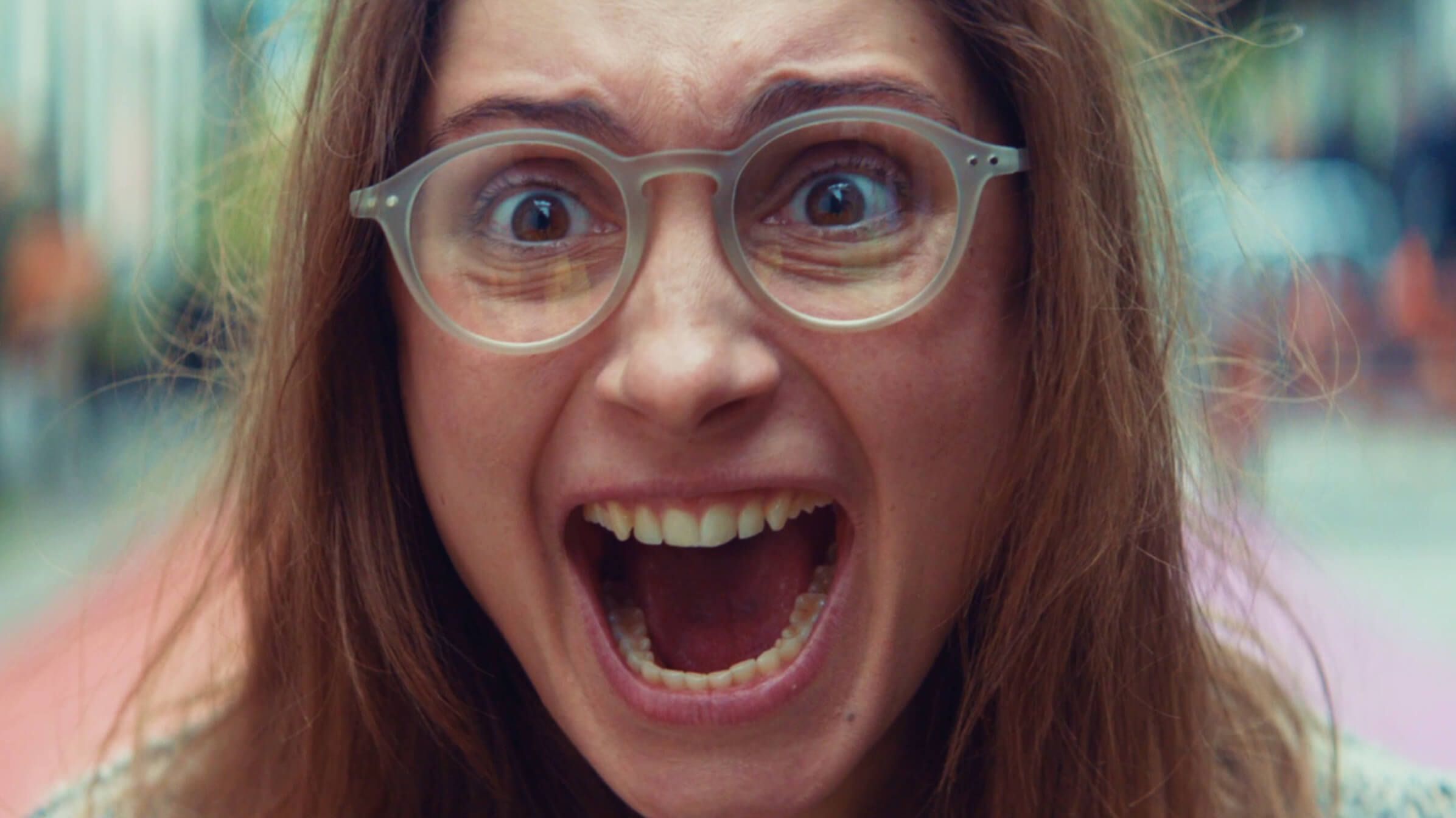 Woman wearing glasses screaming 